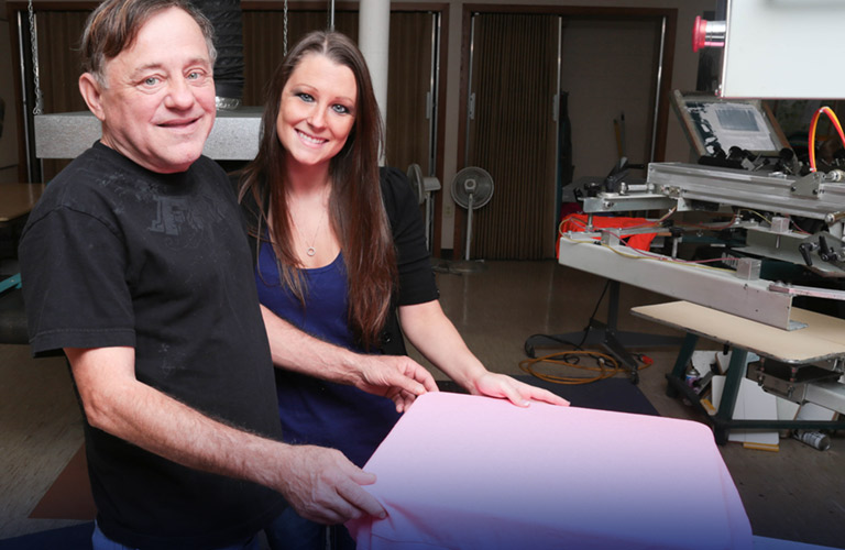 man and woman in screen printing shop