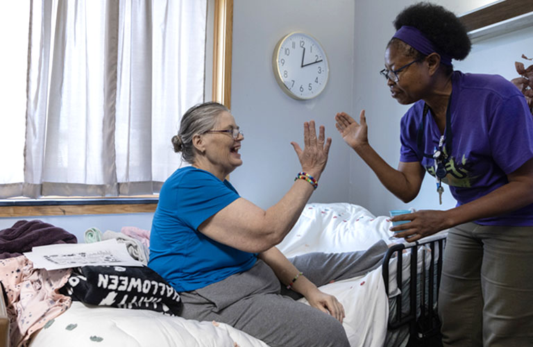 woman giving another woman a high-five