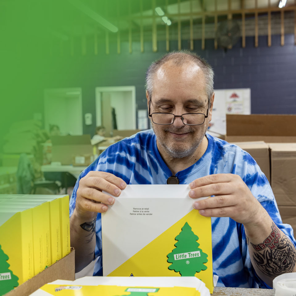 man in glasses sealing an envelope