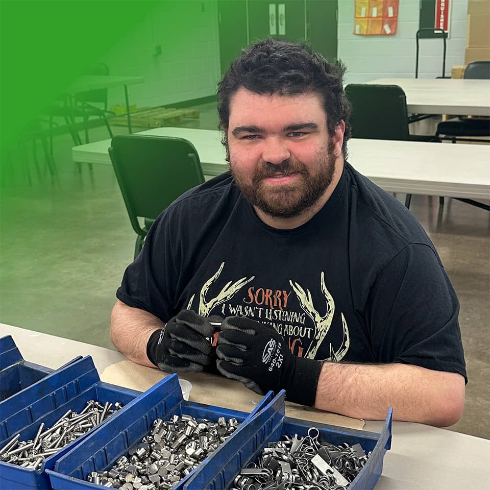 man smiling and sorting materials