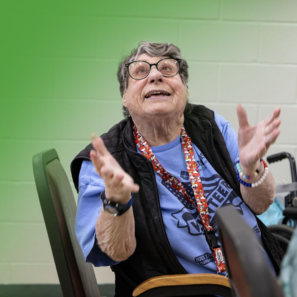 woman looking up with her hands up in the air