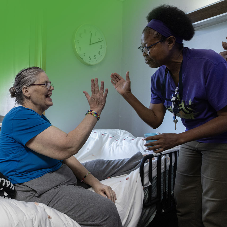 woman helping and giving another women a high-five